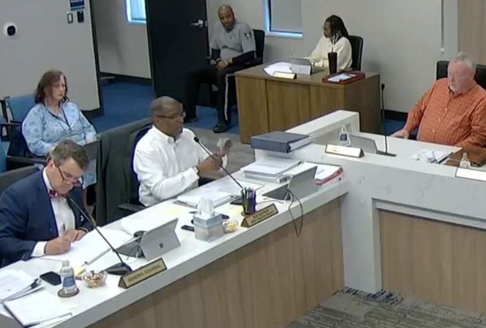 Macon Water Authority Executive Director Ron Shipman cuts his purchasing card in two during a contentious meeting March 6.